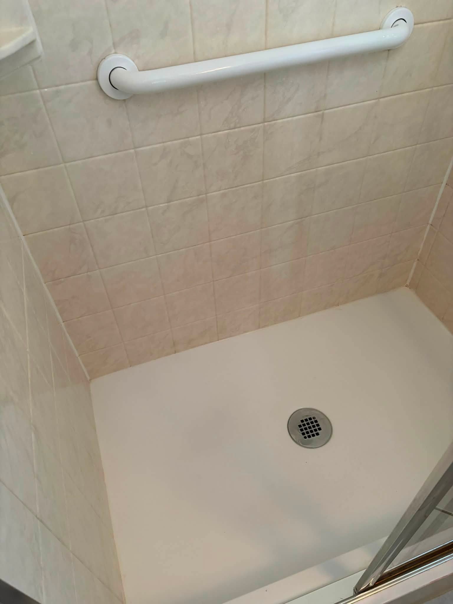 A shower floor and tiles after a deep clean